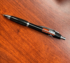 A black and silver ball pint pen with the Combat Stress logo printed in orange and white